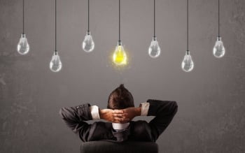 Businness guy in front of idea light bulbs concept