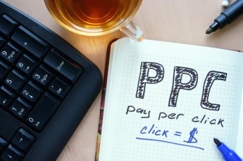 Notepad with words PPC pay per click  concept and marker.