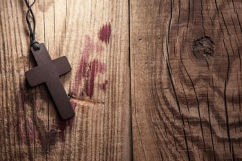 Cross on wooden background