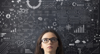Businesswoman idea concept on blackboard