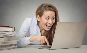 Funny woman working on computer ready to press enter button
