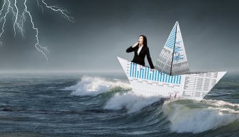 Businesswoman in boat made of paper