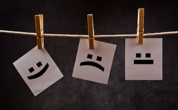 Emoticons on note paper attched to rope with clothes pins