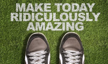 Top View of Sneakers on the grass with the text: Make Today Ridiculously Amazing
