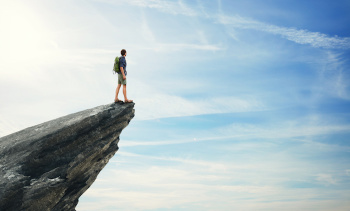 Young man standing on a peak