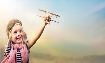 Freedom To Dream – Joyful Child Playing With Airplane Against The Sky