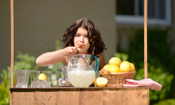 little girl making lemonade