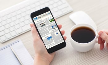 Women hands holding phone with world news site on screen