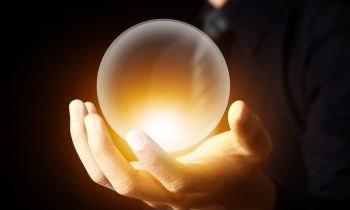Businessman hand holding a Crystal Ball