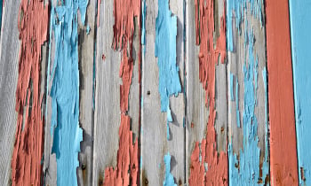 closeup of a old cracked fence with flaking paint.
