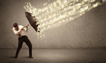 Business man holding umbrella against dollar rain concept