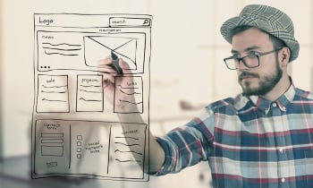 web designer drawing website development wireframe at office