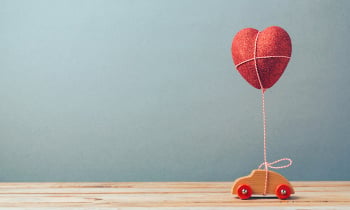 Valentine’s day holiday celebration with toy car and heart shape