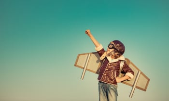 Happy child playing with toy airplane