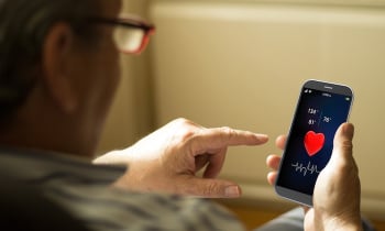Portrait of a mature man with health app on a mobile phone