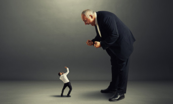 boss screaming at small startled worker