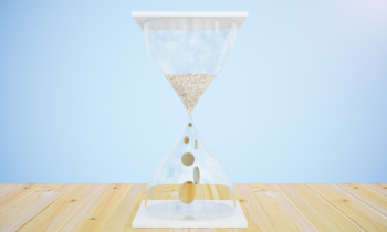 Time is money concept with with hourglass and coins instead sand on wooden table