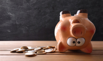 Concept of spending the savings with piggy bank upside down