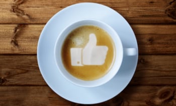 Thumbs up sign in coffee