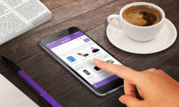 woman on line shopping with smart phone on wooden table relax time with coffee newspaper pencil growing marketing concept
