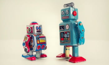 Filtered vintage tin toy robots isolated on white background