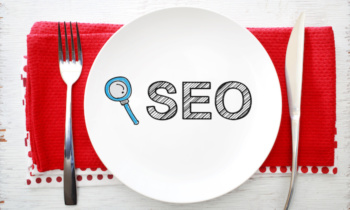 SEO concept on white plate with fork and knife