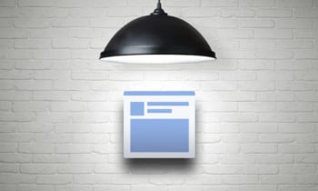 White brick wall illuminated by the lamp with copy space