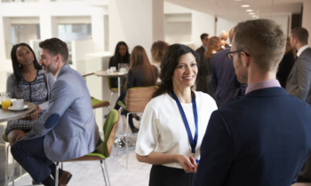 Delegates Networking During Coffee Break At Conference