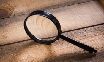 magnifying glass on the wooden background