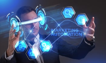 Business, Technology, Internet and network concept. Young businessman working in virtual reality glasses sees the inscription: Marketing automation