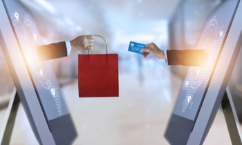 e-commerce, hand holding shopping bag and credit card from screen and global network, shopping and payments online concept