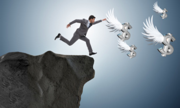 Businessman chasing angel dollars in business concept