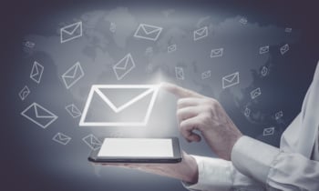 The concept of email marketing. Businessman makes sending emails from your tablet