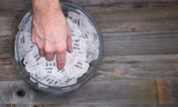 Reaching into a bowl of raffle tickets to find a winner