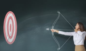 Businesswoman with bow and arrow