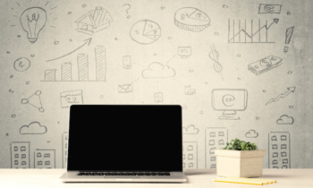 Urban sales graphs and laptop on desk