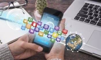 hand holding smart phone with application icons interface and globe networking system. concept technology social network communication.