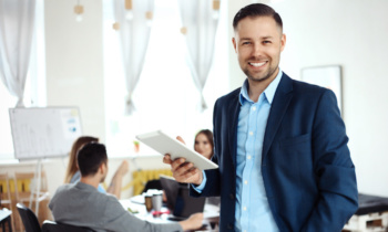 Businessman using his tablet in office