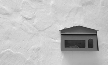 black-mailbox-grey-wall