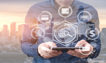 The abstract double exposure image of the business man point to the hologram on smartphone and cityscape is backdrop. The concept of online shopping, online payment, financial and internet of things.