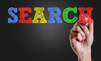 Hand writing the text: Search