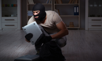 Burglar wearing balaclava mask at crime scene