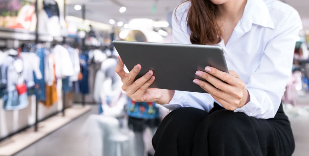 mulher acessando tablet em loja fisica