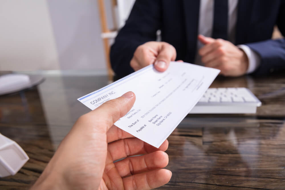 funcionario recebendo seu salario em cheque