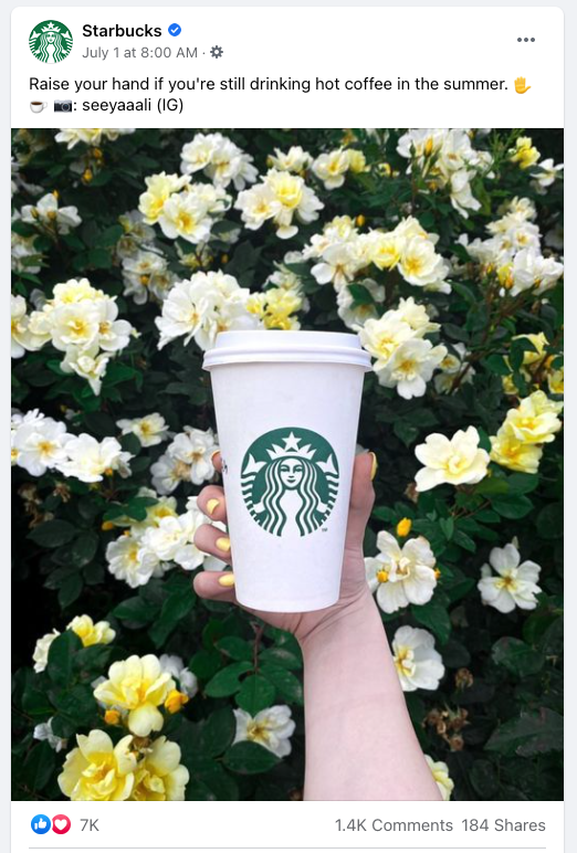 facebook post- hand holds starbucks cup in front of yellow and white flowers