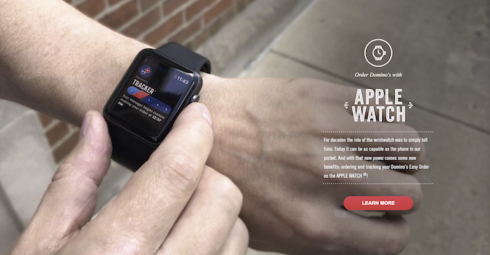 An image of an Apple Watch with a Domino's pizza tracker on the screen. 