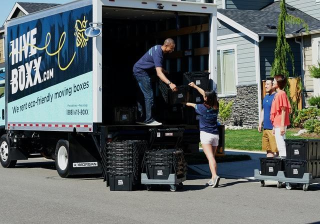 A antheral   successful  a motortruck  helping unload it. 