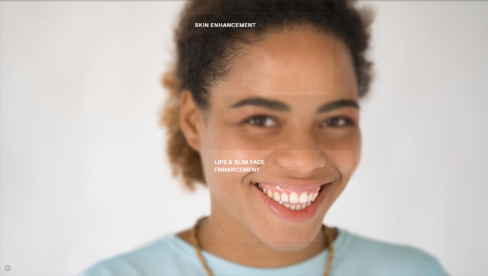 An representation  of a pistillate   smiling is being edited with skin, lip, and slim look   enhancement connected  Luminar AI.