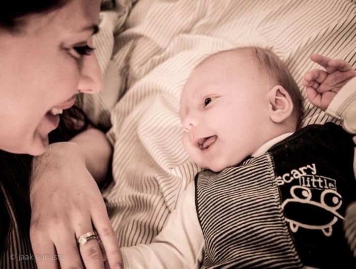 A mother and her baby both smiling.