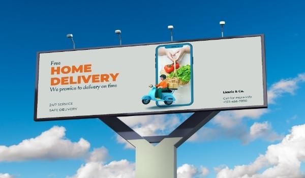 A large digital billboard shows an advertisement that reads, Free Home Delivery